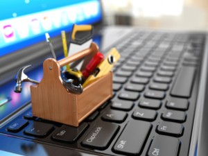 Toolbox with tools on laptop
